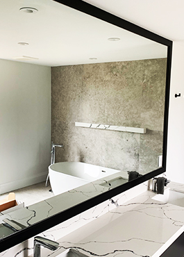 custom made wooden stool with glass seat placed over natural wood